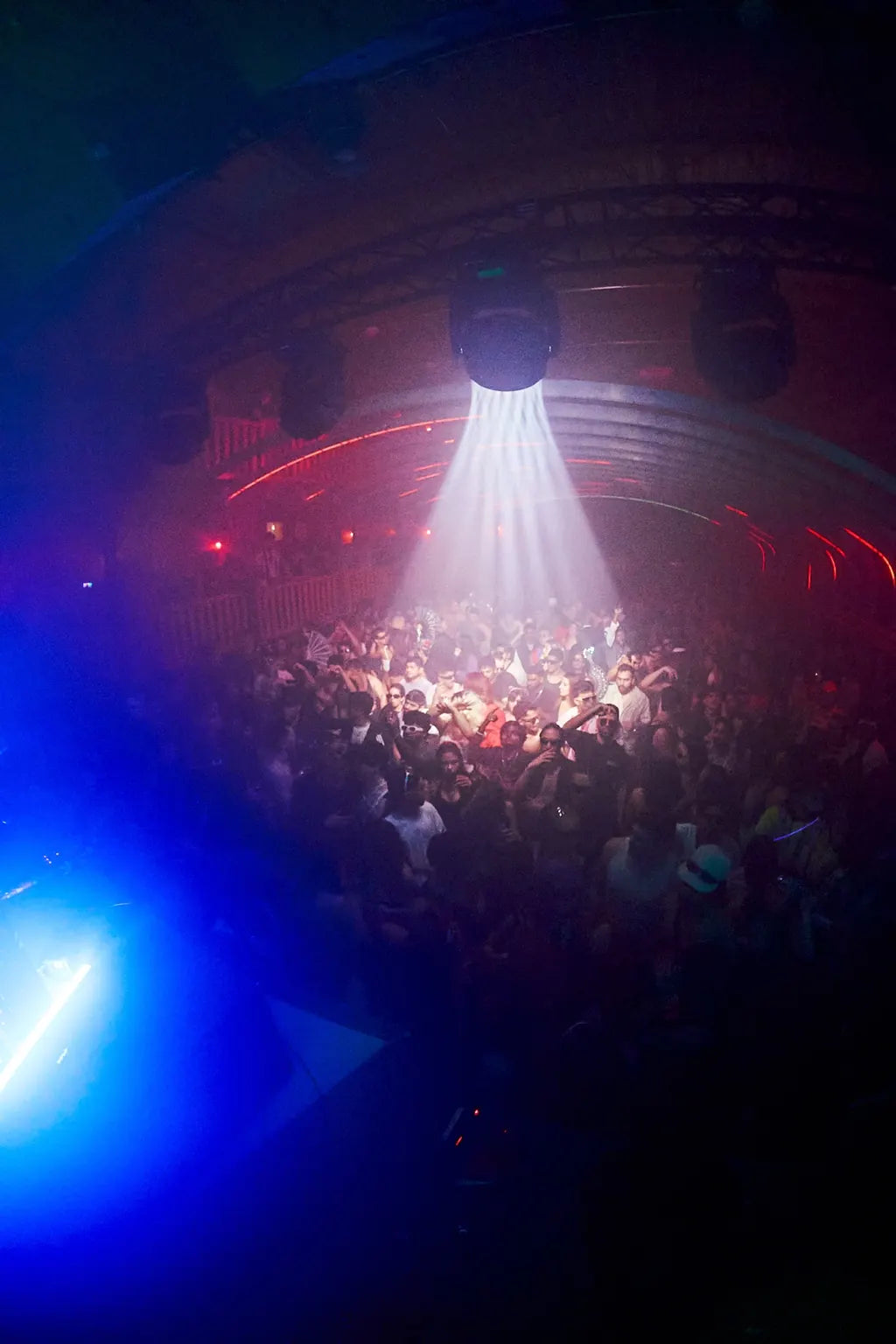 A packed dancefloor under white and blue lights at Halloween 2025