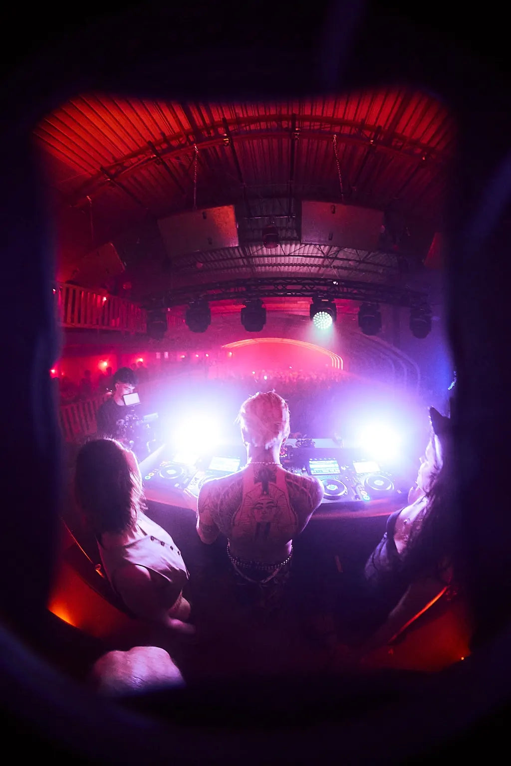 A view toward the stage beneath red ceiling lights at Halloween 2025